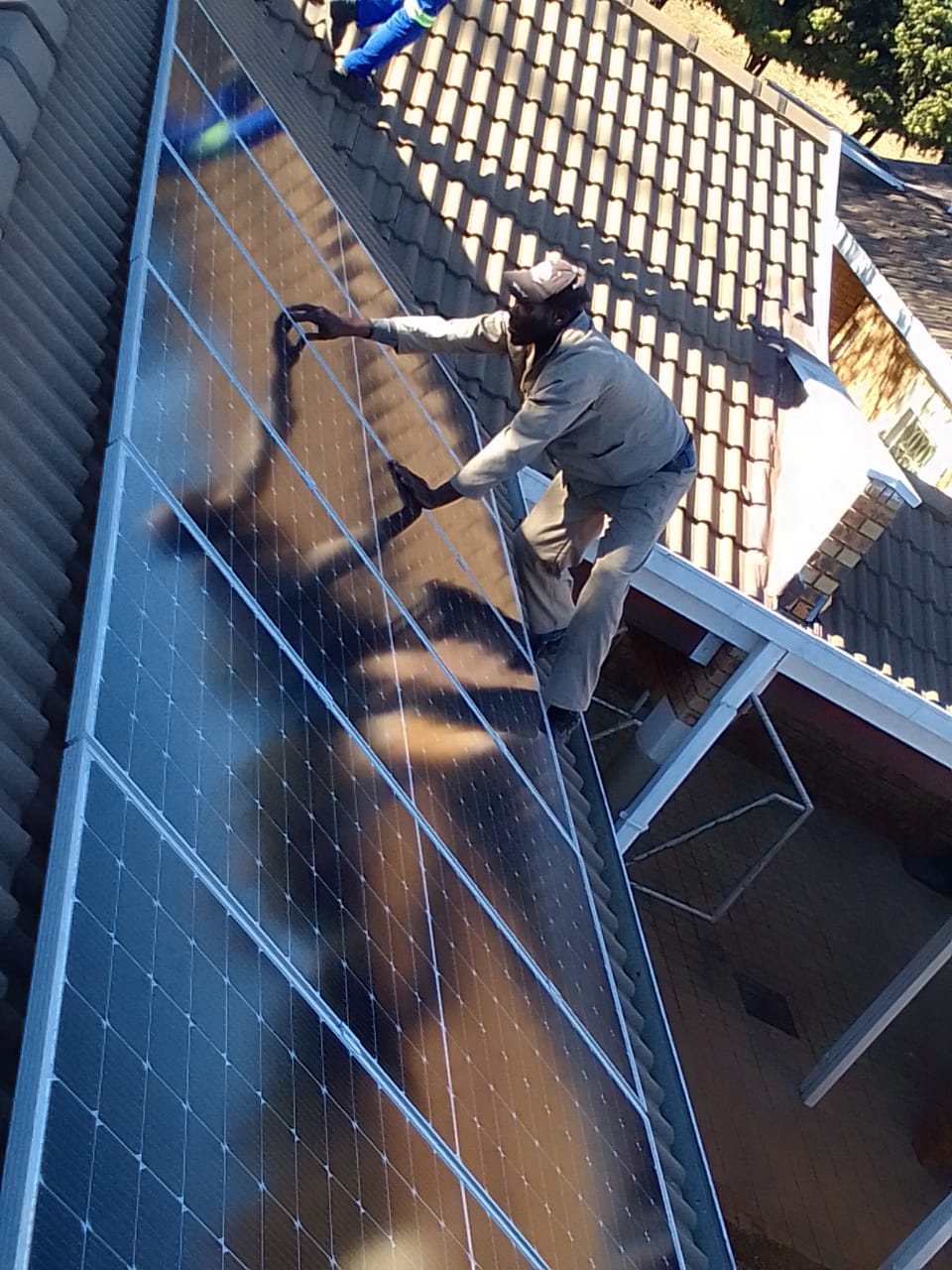 Professional tiler aligning ceramic tiles for seemless pattern