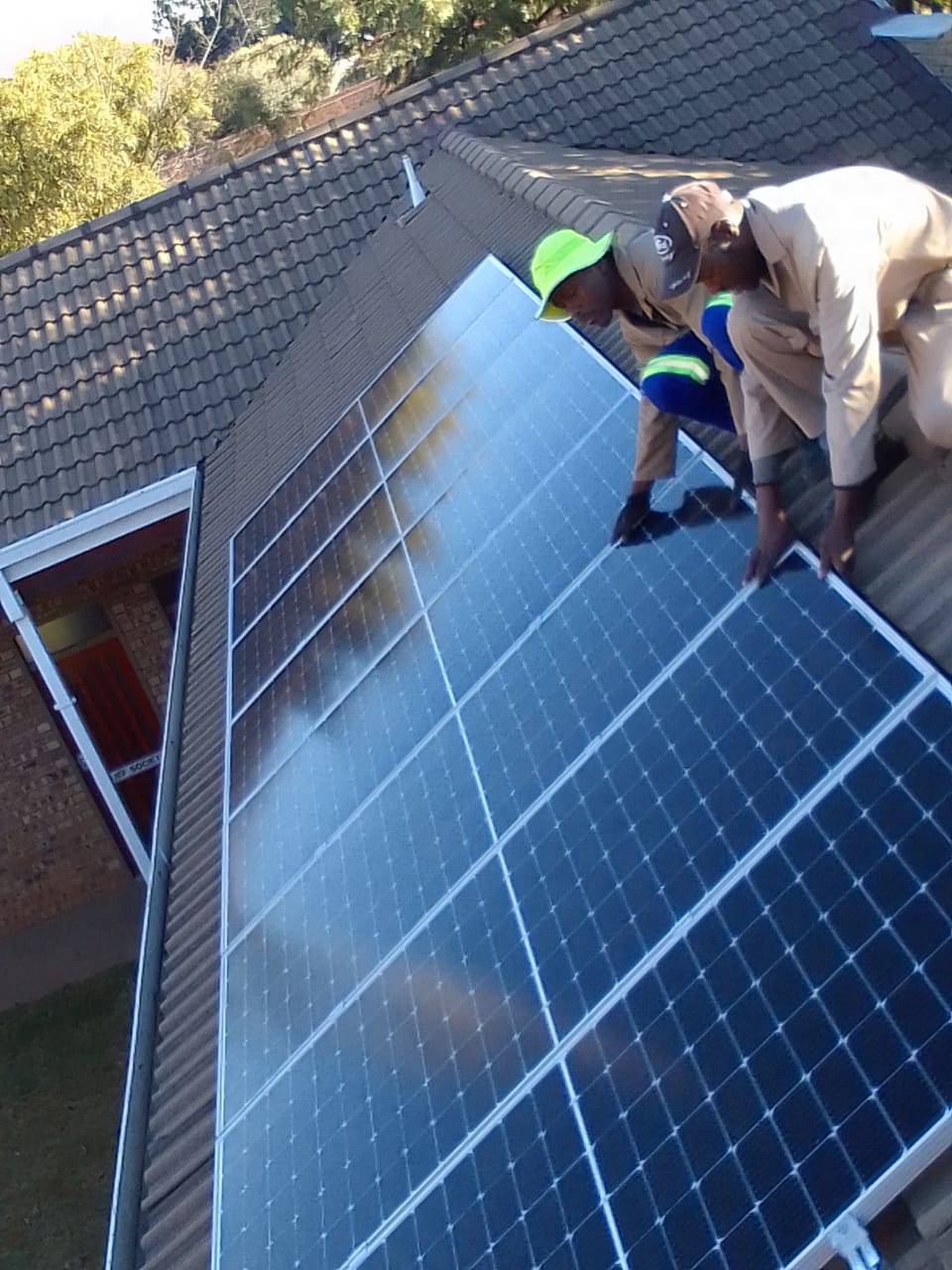 Professional tiler aligning ceramic tiles for seemless pattern